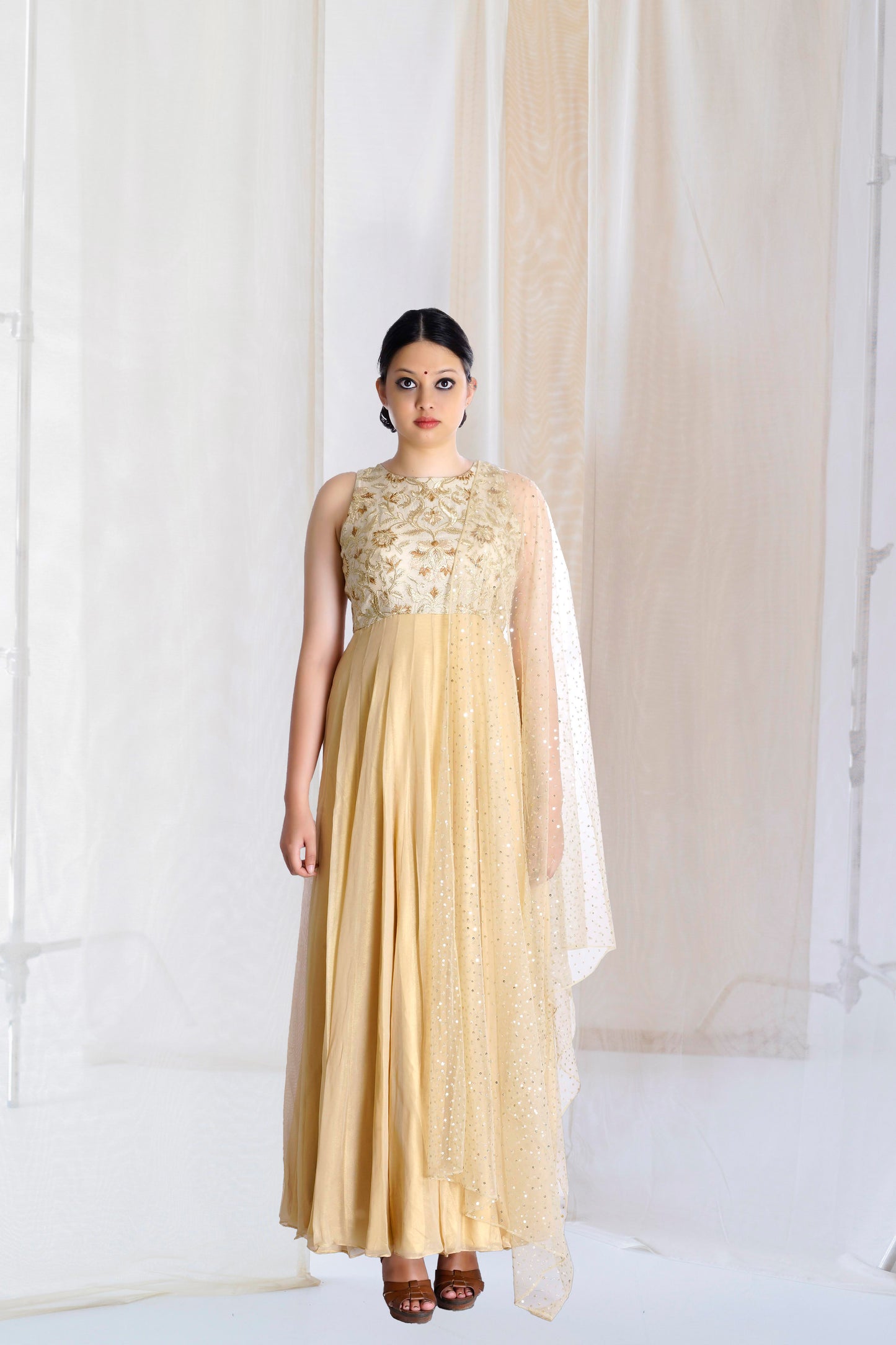 beige and gold kurta set with flare and indian embroidery and motifs made in sleeveless form